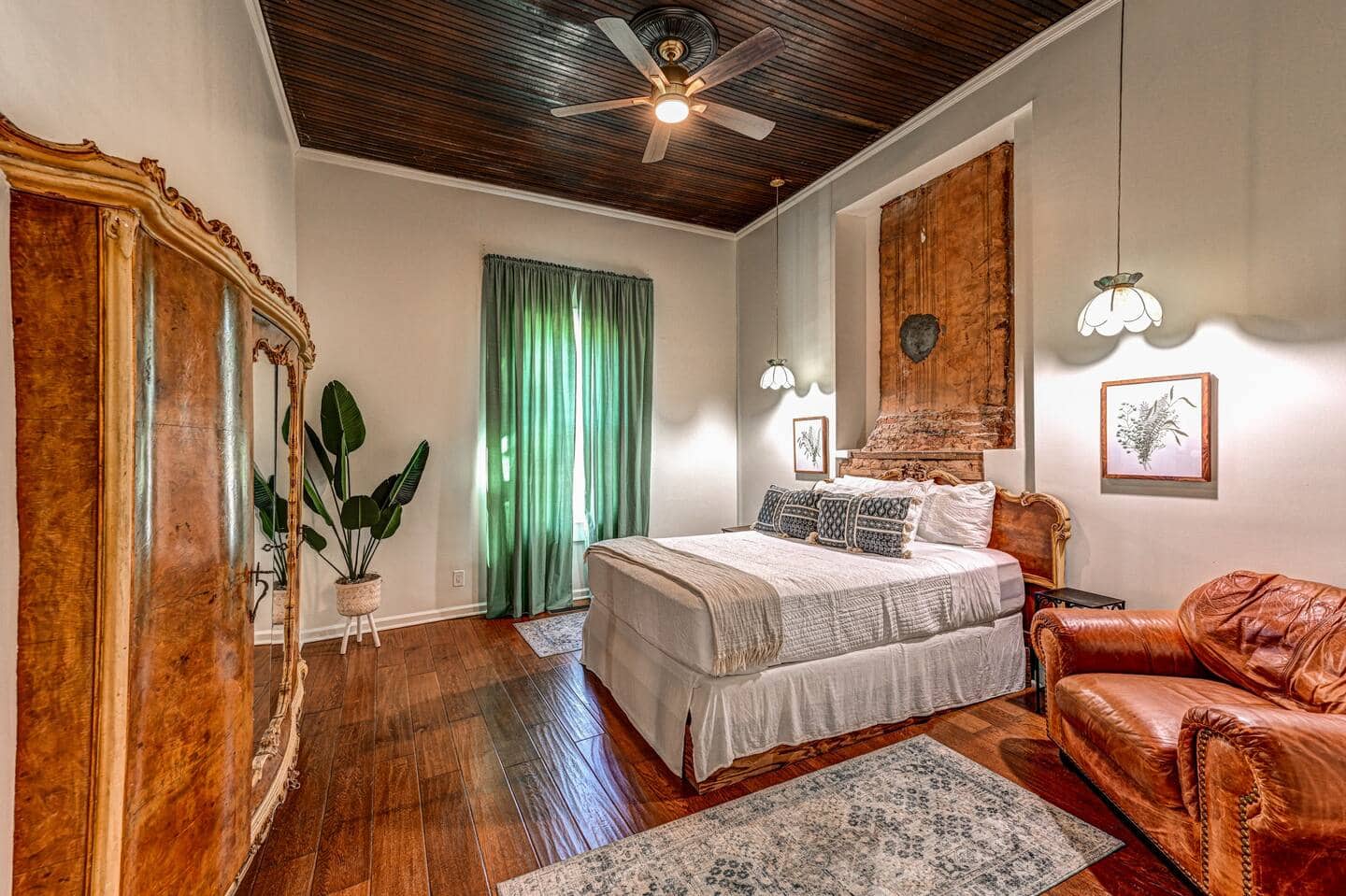 Bedroom suite with antique armoire and wood ceiling