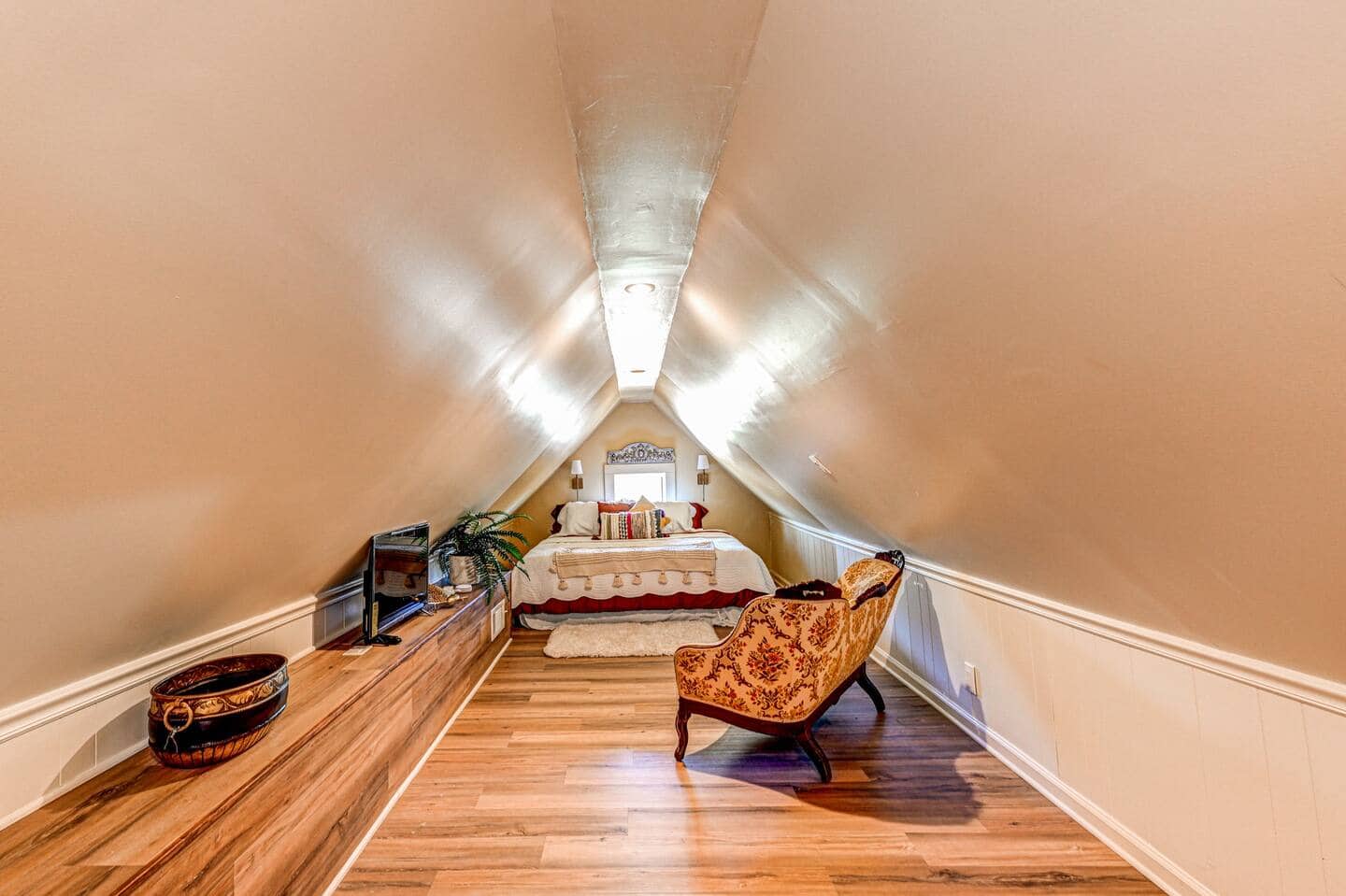 Attic suite with Victorian chaise and sloped ceiling