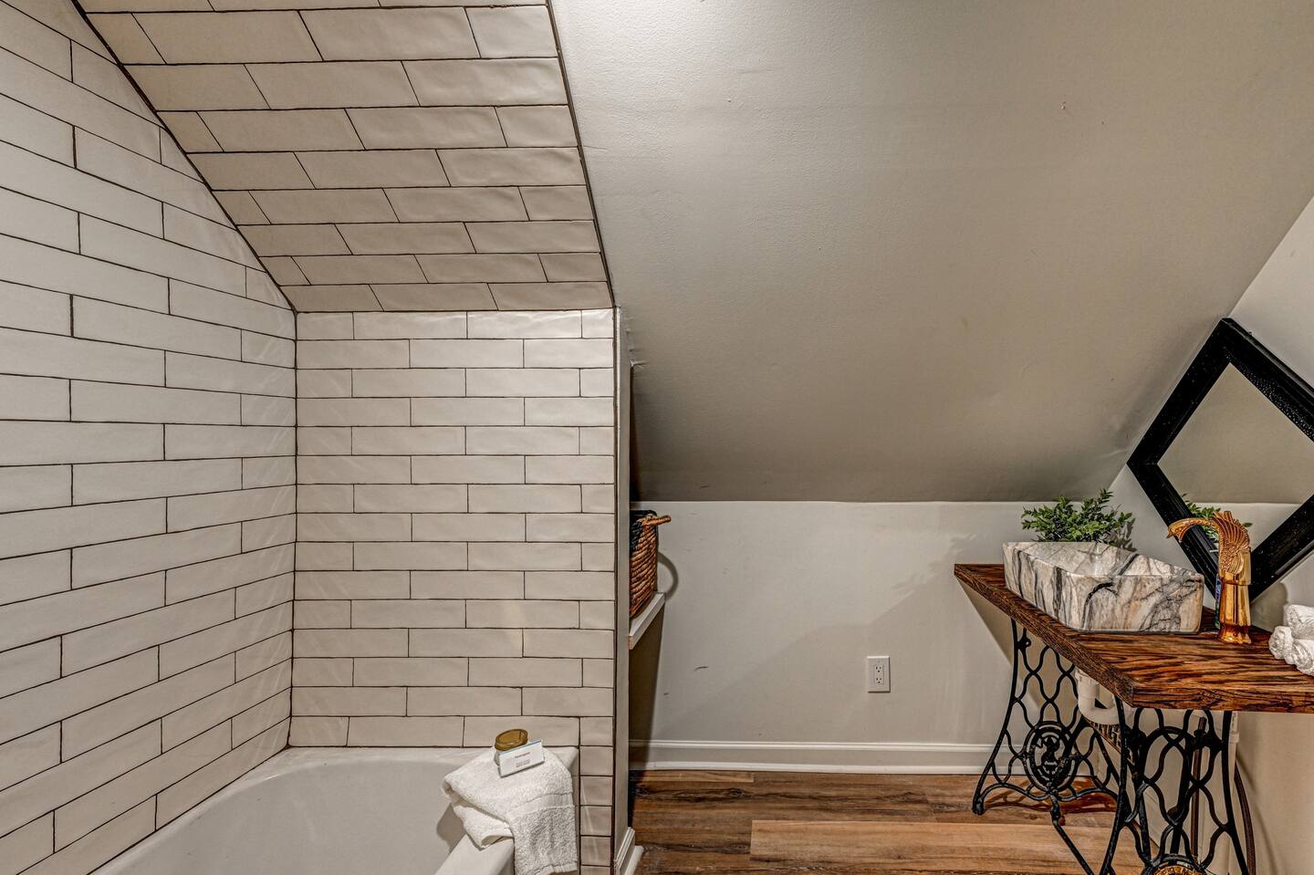 The Sparrow: en-suite with sloped subway tile and sewing-machine vanity